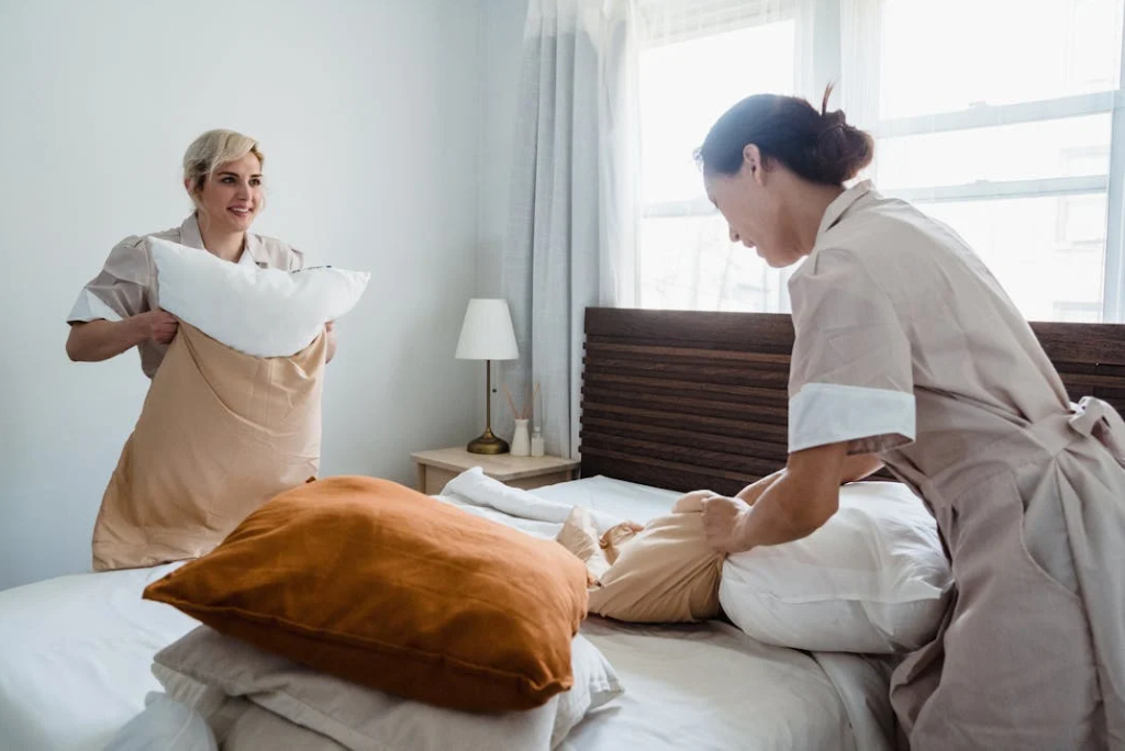 Commercial Cleaning Services - GDI Employee Cleaning Glass Lobby Door Handle